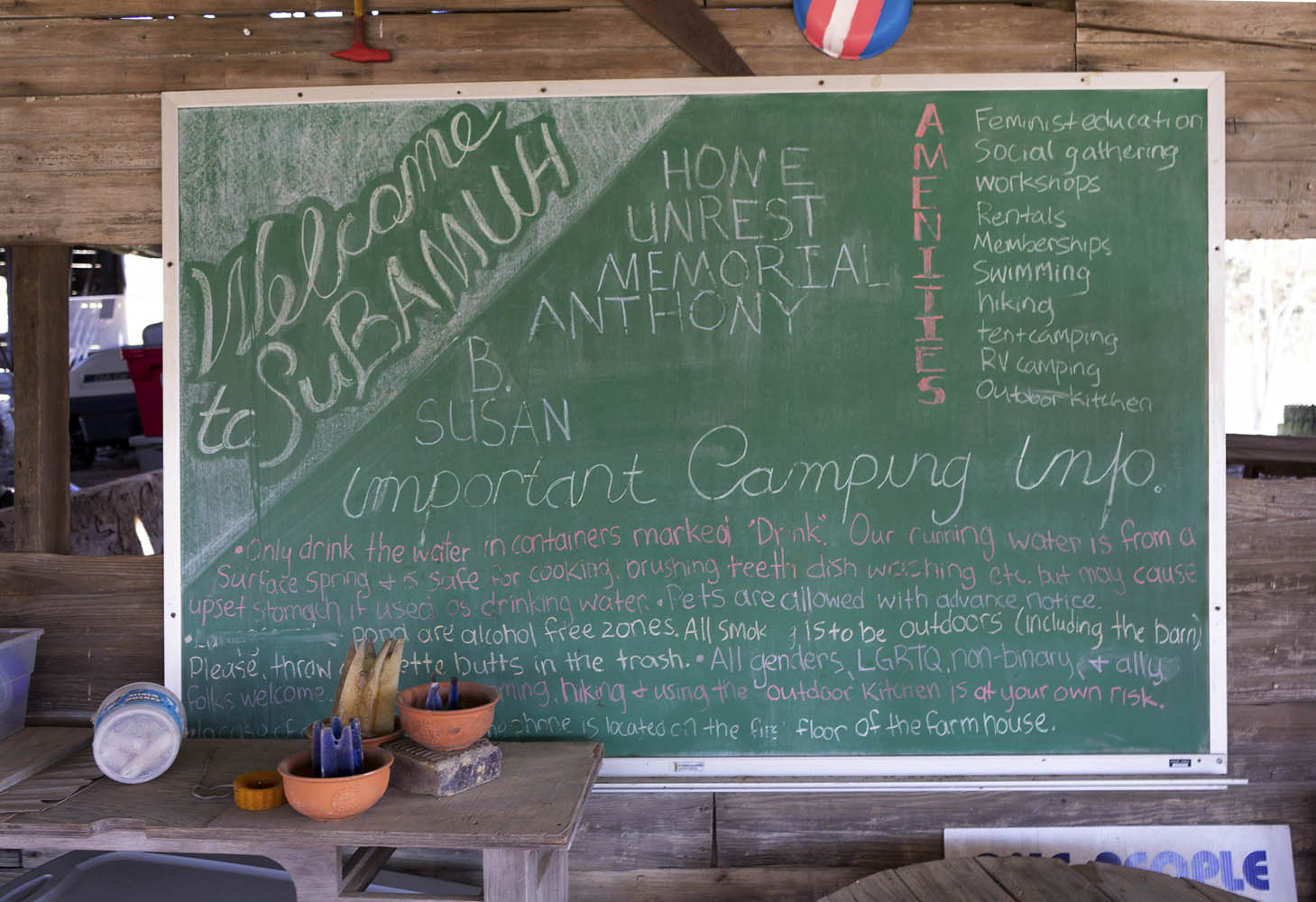 A chalkboard reads Welcome to SuBAMUH. The board goes on to explain the rules of the community.