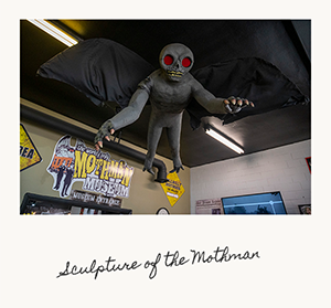 A sculpture of the Mothman suspended in air